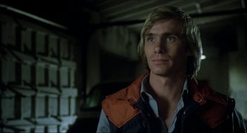 Movie still from “The Stunt Man” (1980), directed by Richard Rush – A person wearing a jacket; Close Up shot, Over the shoulder angle