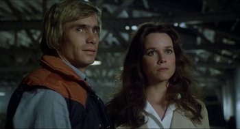 Movie still from “The Stunt Man” (1980), directed by Richard Rush – A man and a woman standing next to each other; Close Up shot, Low angle