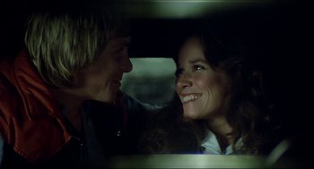 Movie still from “The Stunt Man” (1980), directed by Richard Rush – A man and a woman are smiling in a car; Close Up shot, Low angle