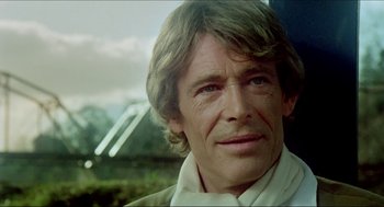 Movie still from “The Stunt Man” (1980), directed by Richard Rush – A person wearing a white shirt; Close Up shot, Over the shoulder angle