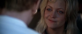 Movie still from “The Sugarland Express” (1974), directed by Steven Spielberg – A person smiling; Close Up shot, Over the shoulder angle