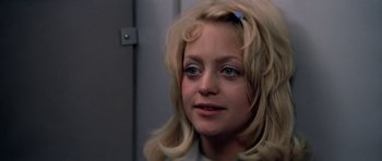 Movie still from “The Sugarland Express” (1974), directed by Steven Spielberg – A person with long blonde hair; Close Up shot, Low angle