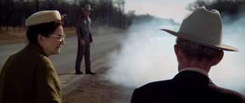 Movie still from “The Sugarland Express” (1974), directed by Steven Spielberg – A man in a cowboy hat is standing on the side of the road; Medium shot, Low angle