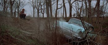 Movie still from “The Sugarland Express” (1974), directed by Steven Spielberg – A car that is driving down a road; Extreme Wide shot, High angle