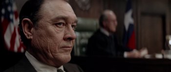 Movie still from “The Sugarland Express” (1974), directed by Steven Spielberg – A man in a suit and tie sitting in front of another man in a suit and tie; Close Up shot, Low angle