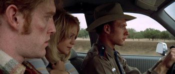 Movie still from “The Sugarland Express” (1974), directed by Steven Spielberg – A man and a woman sitting in the back of a car; Close Up shot, Low angle