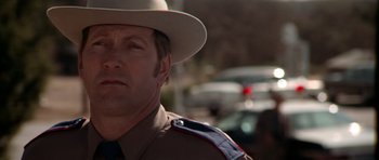 Movie still from “The Sugarland Express” (1974), directed by Steven Spielberg – A person wearing a hat; Close Up shot, Low angle