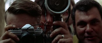 Movie still from “The Sugarland Express” (1974), directed by Steven Spielberg – A man holding a camera up to his face; Extreme Close Up shot, Low angle