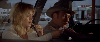 Movie still from “The Sugarland Express” (1974), directed by Steven Spielberg – A man and a woman sitting in the back seat of a car; Close Up shot, Over the shoulder angle