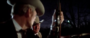 Movie still from “The Sugarland Express” (1974), directed by Steven Spielberg – A man in a cowboy hat is looking at another man in a cowboy hat; Close Up shot, Low angle