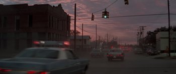 Movie still from “The Sugarland Express” (1974), directed by Steven Spielberg – Cars driving down a street under a traffic light; Extreme Wide shot, High angle