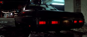 Movie still from “The Sugarland Express” (1974), directed by Steven Spielberg – The back end of a car with red lights on it; Wide shot, Low angle