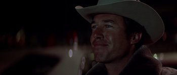 Movie still from “The Sugarland Express” (1974), directed by Steven Spielberg – A person wearing a cowboy hat; Close Up shot, Over the shoulder angle