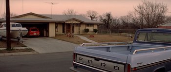 Movie still from “The Sugarland Express” (1974), directed by Steven Spielberg – The back of a truck parked in front of a house; Wide shot, Low angle