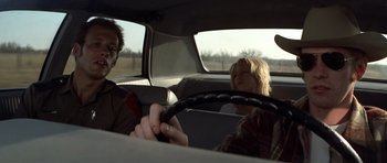 Movie still from “The Sugarland Express” (1974), directed by Steven Spielberg – A man and two women sitting in the back seat of a car; Medium shot, Over the shoulder angle