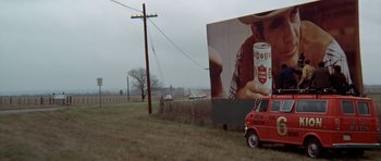 Movie still from “The Sugarland Express” (1974), directed by Steven Spielberg – A large billboard on the side of the road; Extreme Wide shot, Low angle