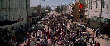 Movie still from “The Sugarland Express” (1974), directed by Steven Spielberg – A crowd of people walking down a street; Extreme Wide shot, High angle
