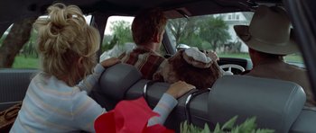 Movie still from “The Sugarland Express” (1974), directed by Steven Spielberg – A man and a woman in the back seat of a car; Medium shot, Over the shoulder angle