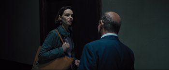 Movie still from “The Super” (2017), directed by Stephan Rick – A woman talking to a man in front of a door; Medium shot, Over the shoulder angle