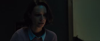 Movie still from “The Super” (2017), directed by Stephan Rick – A woman with short brown hair is looking at the camera; Close Up shot, Low angle