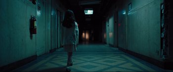 Movie still from “The Super” (2017), directed by Stephan Rick – A little girl walking down a hallway at night; Wide shot, High angle