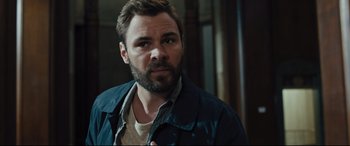 Movie still from “The Super” (2017), directed by Stephan Rick – A person with a beard; Close Up shot, Over the shoulder angle