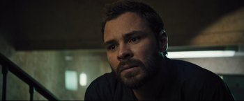 Movie still from “The Super” (2017), directed by Stephan Rick – A person with a beard; Close Up shot, Over the shoulder angle