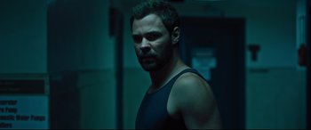Movie still from “The Super” (2017), directed by Stephan Rick – A person wearing a tank top; Close Up shot, Over the shoulder angle
