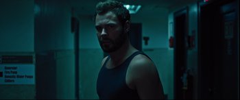 Movie still from “The Super” (2017), directed by Stephan Rick – A person wearing a tank top; Close Up shot, Over the shoulder angle