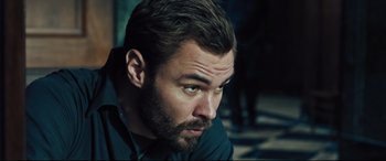 Movie still from “The Super” (2017), directed by Stephan Rick – A person with a beard; Close Up shot, Low angle