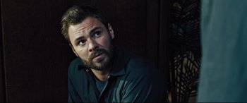 Movie still from “The Super” (2017), directed by Stephan Rick – A person with a beard; Close Up shot, Over the shoulder angle