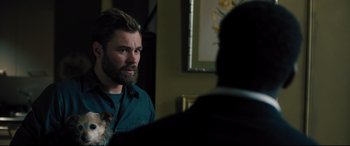 Movie still from “The Super” (2017), directed by Stephan Rick – A man with a beard is talking to a man with a dog; Close Up shot, Over the shoulder angle