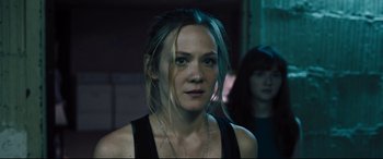 Movie still from “The Super” (2017), directed by Stephan Rick – A person wearing a black tank top; Close Up shot, Over the shoulder angle
