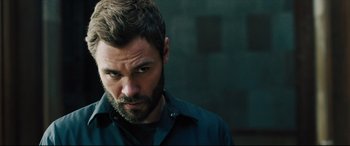Movie still from “The Super” (2017), directed by Stephan Rick – A person with a beard; Close Up shot, Over the shoulder angle