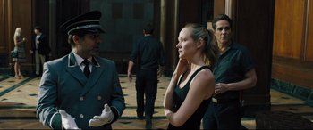 Movie still from “The Super” (2017), directed by Stephan Rick – A woman standing next to a man in a black dress; Medium shot, Over the shoulder angle