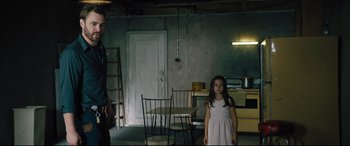 Movie still from “The Super” (2017), directed by Stephan Rick – A man and a little girl standing in a room; Medium shot, Over the shoulder angle