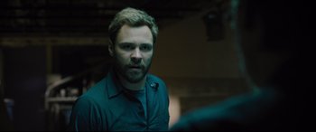 Movie still from “The Super” (2017), directed by Stephan Rick – A person wearing a shirt; Close Up shot, Over the shoulder angle