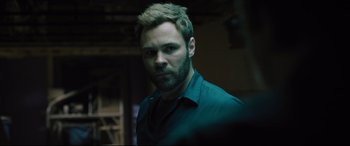 Movie still from “The Super” (2017), directed by Stephan Rick – A person with a beard; Close Up shot, Over the shoulder angle