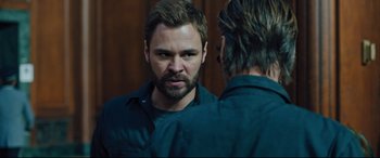 Movie still from “The Super” (2017), directed by Stephan Rick – A man looking at himself in the mirror; Close Up shot, Over the shoulder angle