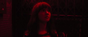 Movie still from “The Super” (2017), directed by Stephan Rick – A woman with long hair and bangs looking up; Close Up shot, Low angle