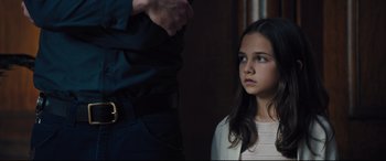 Movie still from “The Super” (2017), directed by Stephan Rick – A young girl and an older man looking at each other; Close Up shot, Over the shoulder angle