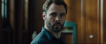 Movie still from “The Super” (2017), directed by Stephan Rick – A person with a beard; Close Up shot, Over the shoulder angle