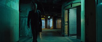 Movie still from “The Super” (2017), directed by Stephan Rick – A man walking down a hallway in an abandoned building; Wide shot, Low angle