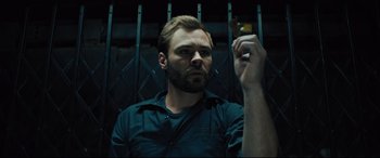 Movie still from “The Super” (2017), directed by Stephan Rick – A man holding a cigarette in his hand; Close Up shot, Low angle