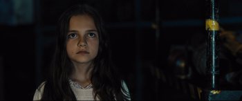 Movie still from “The Super” (2017), directed by Stephan Rick – A young girl is staring into the camera; Close Up shot, High angle