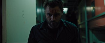 Movie still from “The Super” (2017), directed by Stephan Rick – A person wearing a black shirt; Close Up shot, Low angle