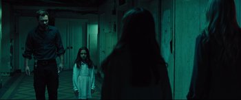Movie still from “The Super” (2017), directed by Stephan Rick – A young girl standing in front of a woman in a hallway; Wide shot, Over the shoulder angle