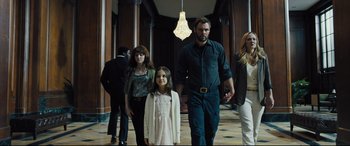 Movie still from “The Super” (2017), directed by Stephan Rick – A group of people walking down a hall way; Wide shot, Low angle
