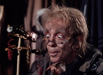 Movie still from “The Tales of Hoffmann” (1951), directed by Michael Powell – An old man with a strange look on his face; Close Up shot, High angle