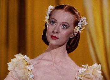 Movie still from “The Tales of Hoffmann” (1951), directed by Michael Powell – A person wearing a dress; Close Up shot, Low angle